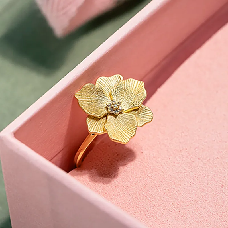 gold plated flower ring with core of small diamonds